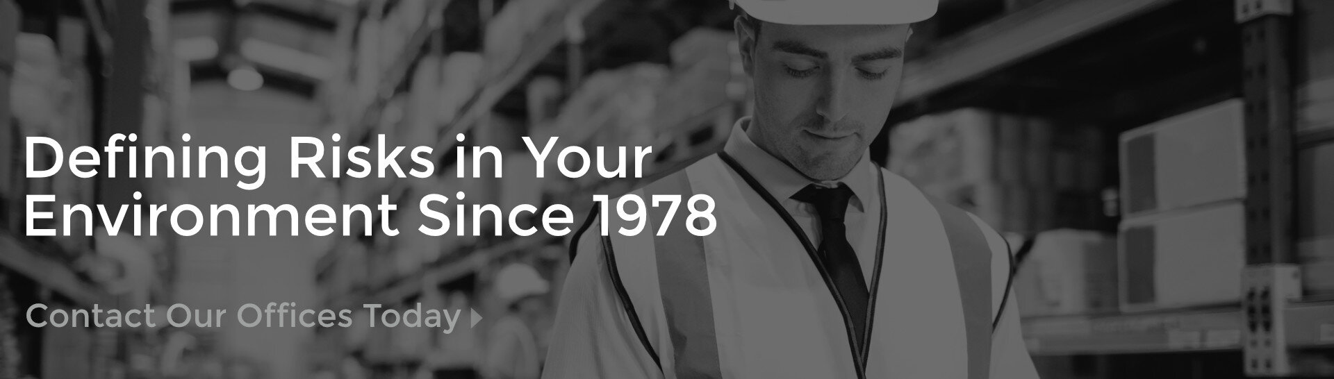 Occupational Safety Consulting - Jurgiel team member inspecting the interior of a warehouse, looking at his tablet